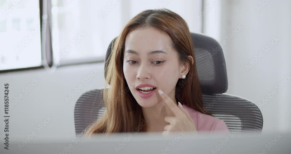 A woman joyfully participates in remote work showcasing her engagement and positivity in a bright office. A woman joyfully participates in remote work showcasing her engagement and positivity in a bright office.
