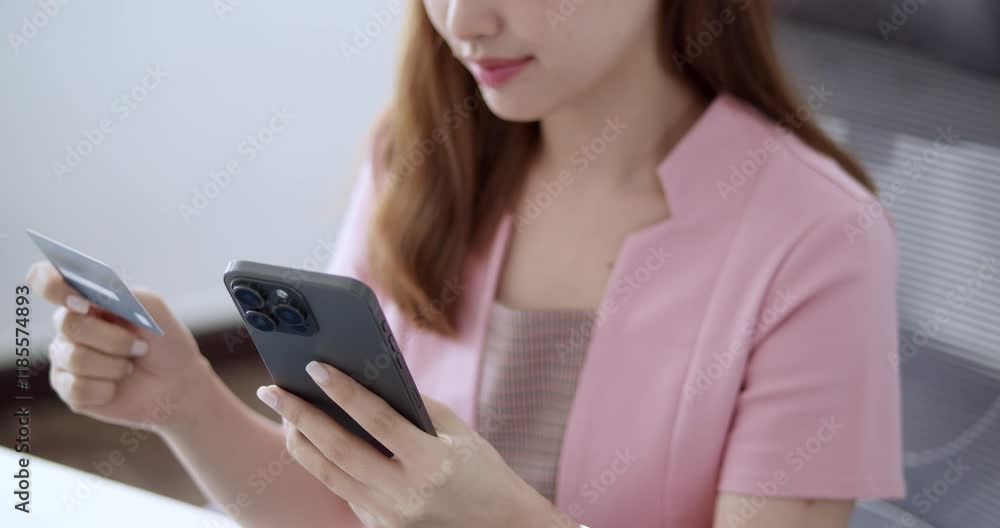 A young woman engages in online shopping showcasing modern digital payment methods in a minimalist environment. A young woman engages in online shopping showcasing modern digital payment methods in a minimalist environment.