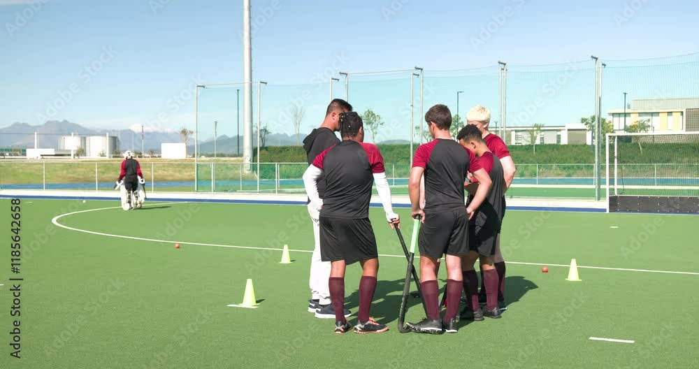 male hockey team huddling on field, discussing strategy during practice session male hockey team huddling on field, discussing strategy during practice session