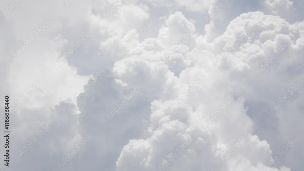 view from plane over blue sky with white Fluffy clouds while flying through in sunny summer time. view from plane over blue sky with white Fluffy clouds while flying through in sunny summer time.