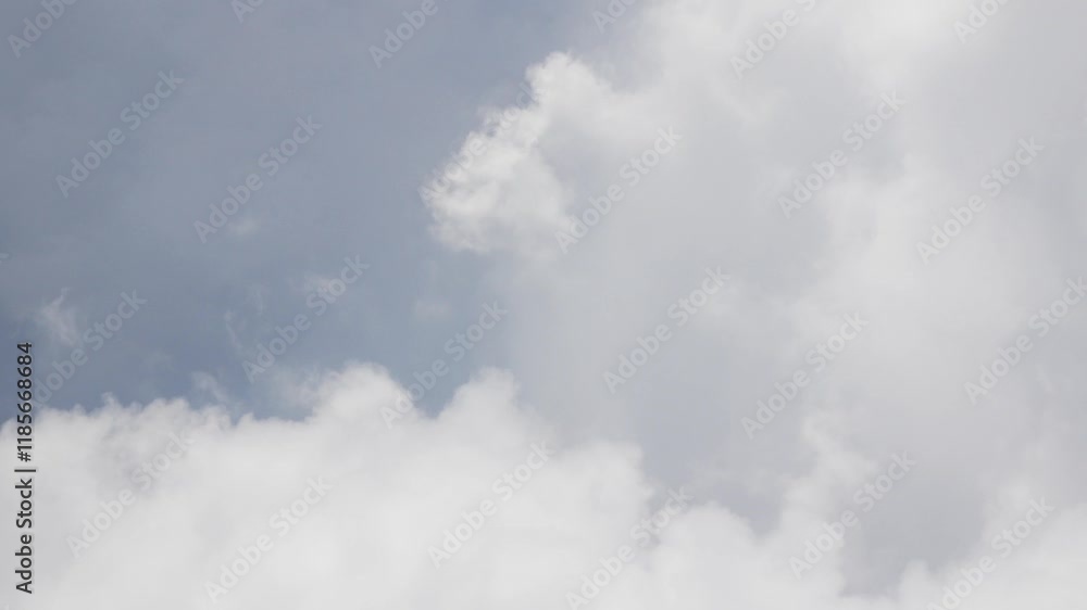 view from plane over blue sky with white Fluffy clouds while flying through in sunny summer time. view from plane over blue sky with white Fluffy clouds while flying through in sunny summer time.