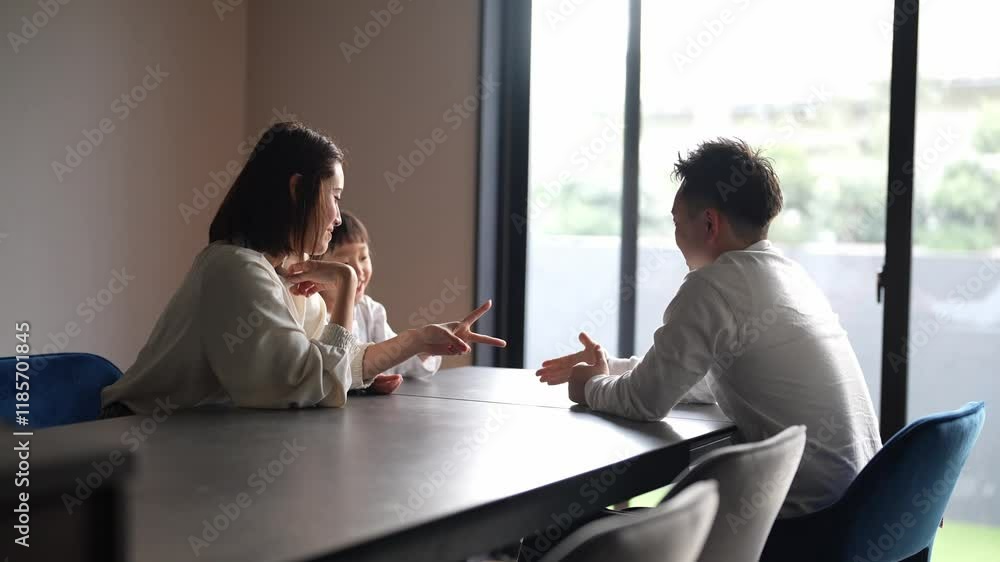 In the living room of their home, a Japanese parent and child - a woman in her 30s, a man in his 20s, and a 6-year-old girl - are playing with their hands. Slow motion video. In the living room of their home, a Japanese parent and child - a woman in her 30s, a man in his 20s, and a 6-year-old girl - are playing with their hands. Slow motion video.