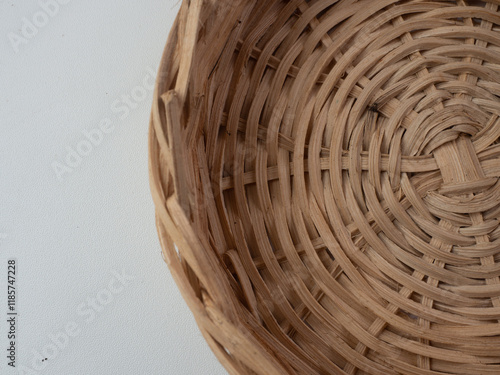 container made of rattan with a white background, usually for kitchen spices. seen from above.