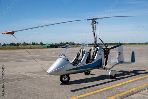 Ein Tragschrauber in der Seitenansicht auf einem Flugfeld mit gesichertem Rotor photo