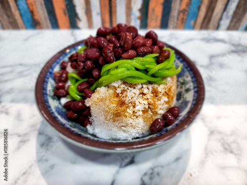 Cendol is a Malaysian dessert made of shaved ice, coconut milk, green pandan jelly noodles, and sweet dark brown sugar syrup. 
