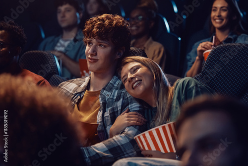 Young happy couple watching romantic movie in theater. photo