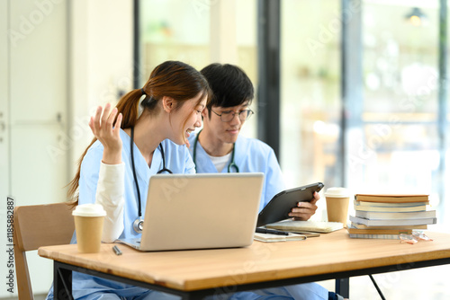 Medical students working together on assignments in a modern study space.