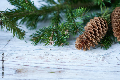 Wallpaper Mural Christmas background with fir branches and cones on white wooden board. Selective focus. Torontodigital.ca