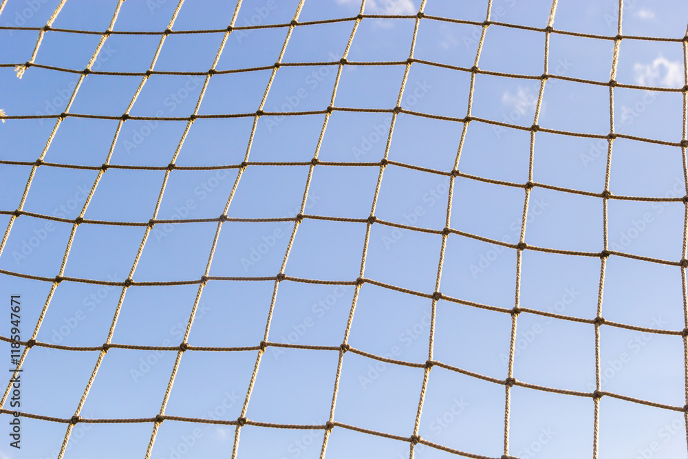 Sports net against a clear blue sky on a sunny day in an open area Sports net against a clear blue sky on a sunny day in an open area