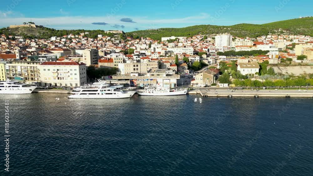 Parallel drone flight, next to a small croatian city. In the foreground is water and a yacht. Parallel drone flight, next to a small croatian city. In the foreground is water and a yacht.