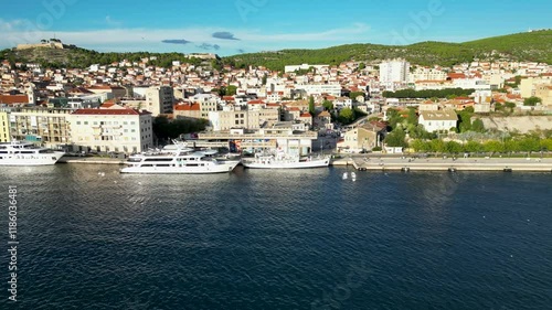 Parallel drone flight, next to a small croatian city. In the foreground is water and a yacht.