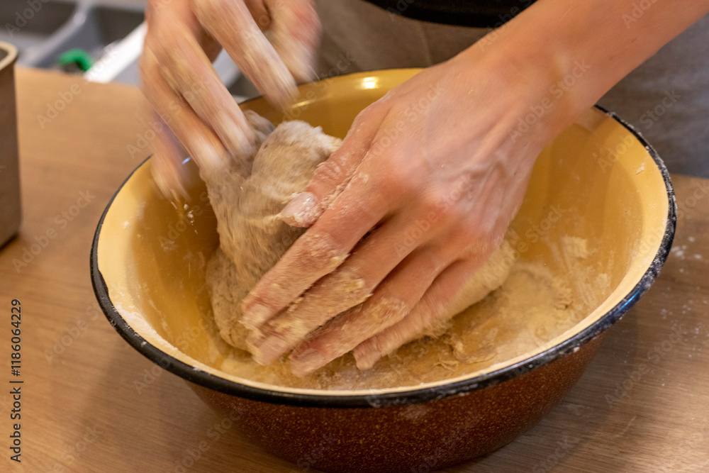 Fototapeta premium Woman kneads the dough in the bowl. Baking