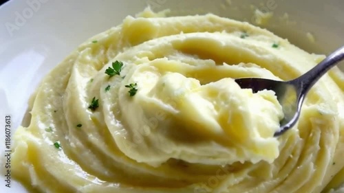 Buttery sheen mashed spoon lifts folds parsley flecks vibrant top or Mashed potatoes buttery sheen spoon