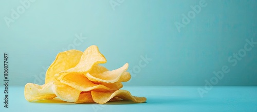 Potato chips on a blue table high in calories referred to as mild drag. with copy space image. Place for adding text or design photo