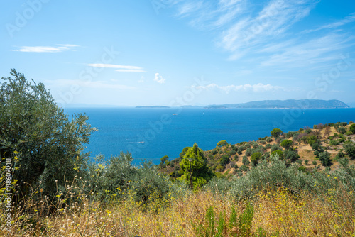 View of the sea, mountains, rocks, beaches, islands and the sky from different sides of the Skopelos island Greece.