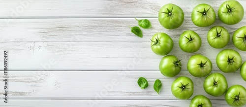 Green unripe tomatoes on a ...