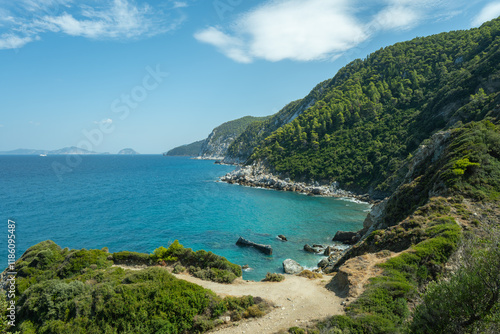 View of the sea, mountains, rocks, beaches, islands and the sky from different sides of the Skopelos island Greece.