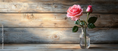 Pink rose in a vase on a wo...