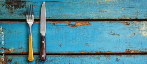 Cupronickel knife and fork on a vibrant wooden surface. with copy space image. Place for adding text or design photo