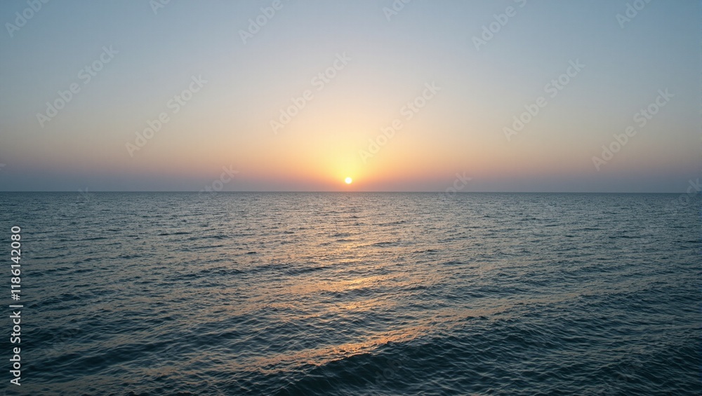 Fototapeta premium Tranquil dawn over a bay golden sun calm waters soft hues reflecting in gentle waves