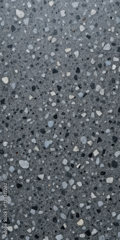Close-up of a speckled gray terrazzo floor with various stone aggregates. Close-up of a speckled gray terrazzo floor with various stone aggregates.