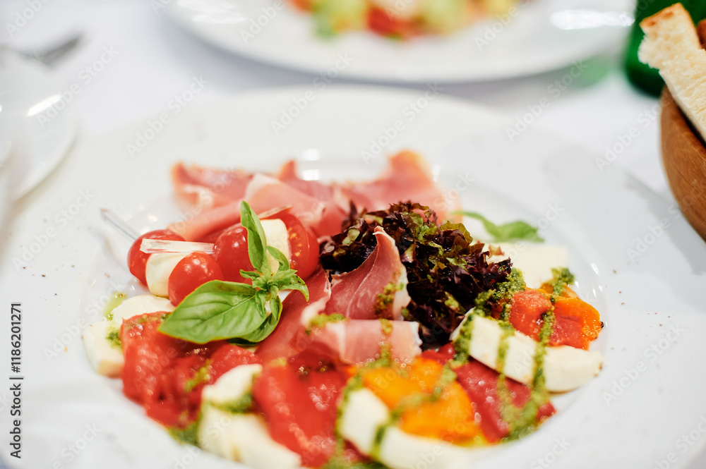 Delicious Italian Appetizer Featuring Fresh Vegetables, Mozzarella, and Flavored Garnishes.. Delicious Italian Appetizer Featuring Fresh Vegetables, Mozzarella, and Flavored Garnishes..