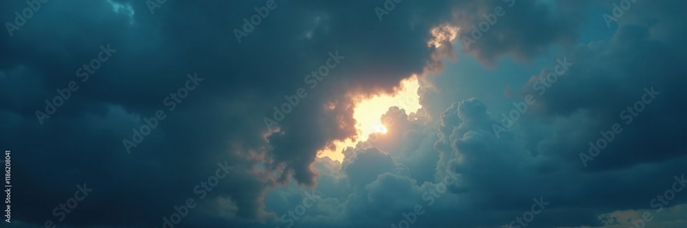 Fototapeta premium A thin sliver of light breaks through thick dark clouds forming a crescent shape on the horizon, stormy weather, cloudy