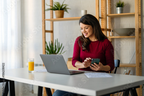 Successful happy professional business woman working on her laptop in a bright home office photo