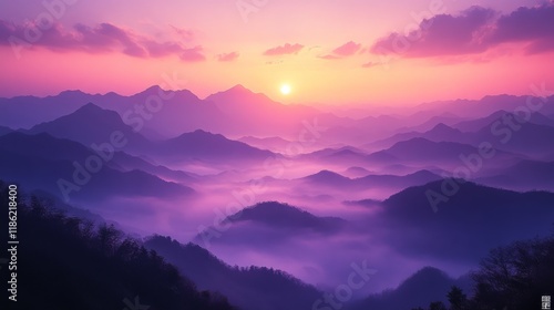 Sunrise over the horizon with colorful clouds and fog blanketing the valleys