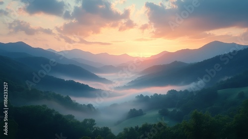 Sunrise over the horizon with colorful clouds and fog blanketing the valleys
