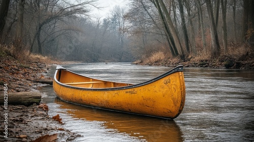 Canoe resting on calm waters surrounded by lush green landscape under a cloud...