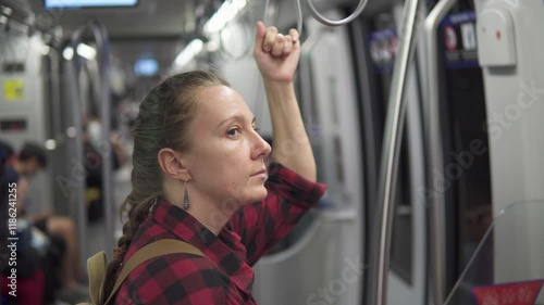 Female tourist with backpack travelling by subway train