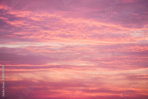 Sunset in the sky in pastel colors. Purple and pink sky with clouds in the evening. Nature background.
