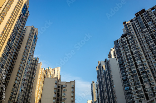Wallpaper Mural A low-angle view of clustered apartment buildings in Liuzhou, China. Concept of real estate oversupply, a densely populated residential neighborhood, and housing development. Torontodigital.ca