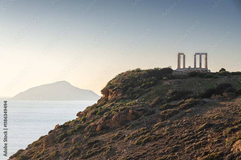 Temple of Poseidon. Beautiful landscape with warm light sky before sunset over Poseidon Temple at Sounion Cape from Greece. Visit and travel to Greece.
