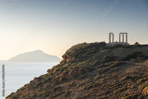 Temple of Poseidon. Beautiful landscape with warm light sky before sunset over Poseidon Temple at Sounion Cape from Greece. Visit and travel to Greece.