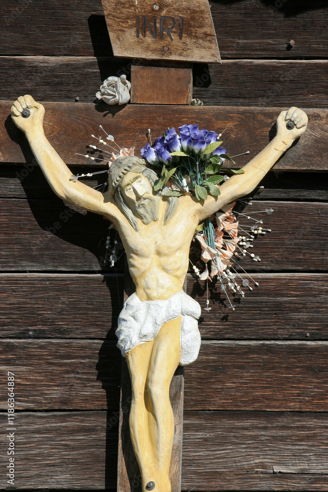 A crucifix on the outer wall of the wooden chapel of Saint Martin in Stari Brod, Croatia