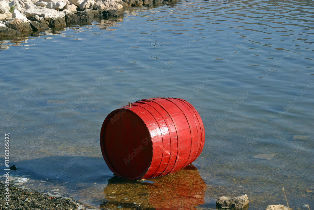 Red barrel near the shore of the sea in Simuni on the island of Pag, Croatia