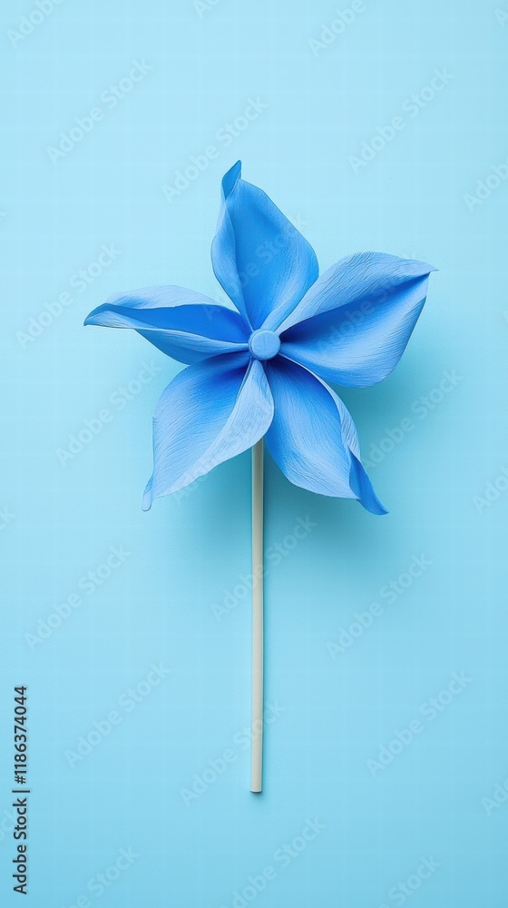 Minimalist blue pinwheel on pastel background with soft lighting Minimalist blue pinwheel on pastel background with soft lighting