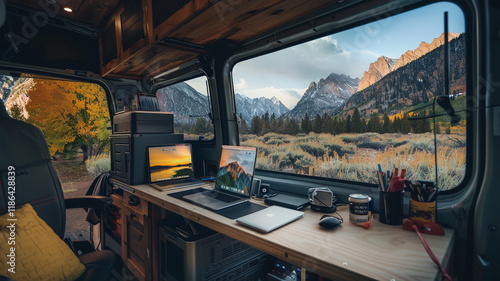 A sleek camper van workspace with a large monitor and fold-out desk, parked in a picturesque mountain location, representing the freedom digital nomads have to work anywhere in nature.