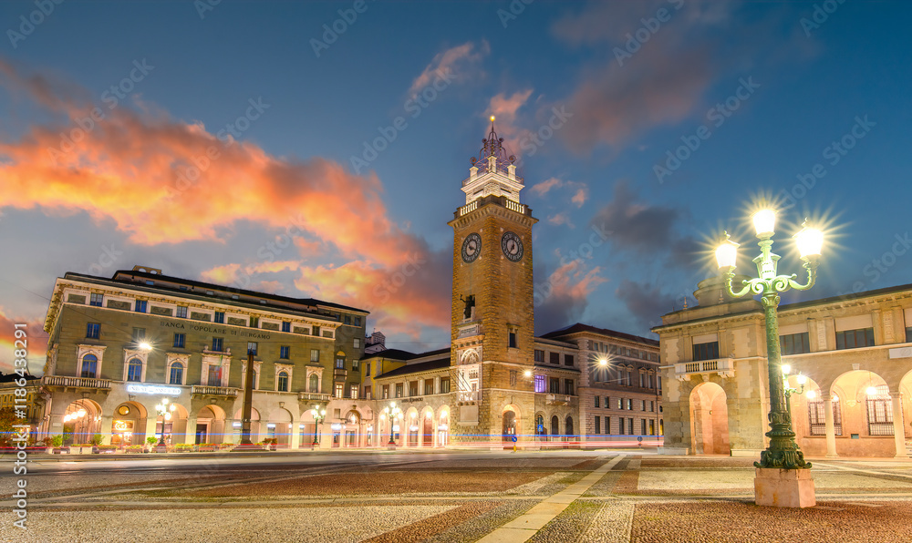 Fototapeta premium Bergamo, Italy. Tower of the fallen or Torre dei Caduti, located on Piazza Vittorio Veneto in the lower city at sunrise