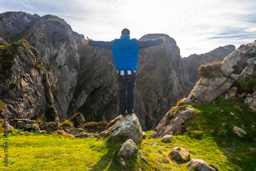 Hiker conquering aiako harria mountain peak in basque country photo