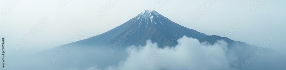 Cloud-covered mountain peak shrouded in mist and fog, shrouded, misty, gray sky Cloud-covered mountain peak shrouded in mist and fog, shrouded, misty, gray sky