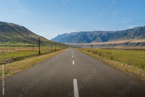 A long unwavering ribbon of asphalt disappearing into the mountains.
