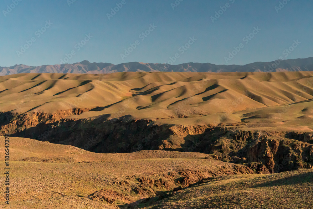 Stiff elevated mountain ranges along side vast expansive plains Stiff elevated mountain ranges along side vast expansive plains
