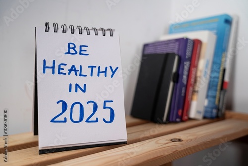Obraz na płótnie otwarty notes na półce z kartką na której widnieje tekst: Be healthy in 2025 w salonie