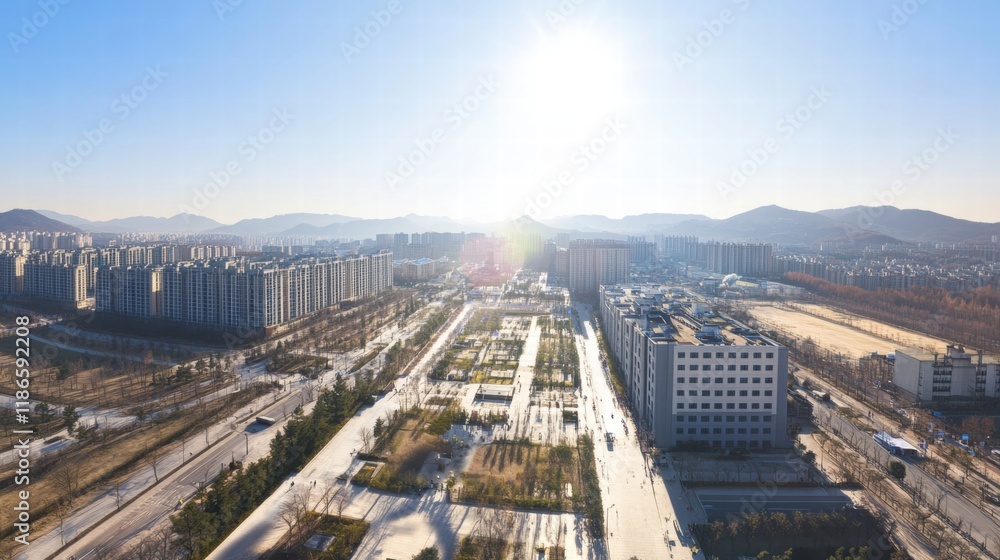 Fototapeta premium Urban Oasis: Aerial view of a modern city with expansive green spaces integrated into the urban landscape. The sun shines brightly.
