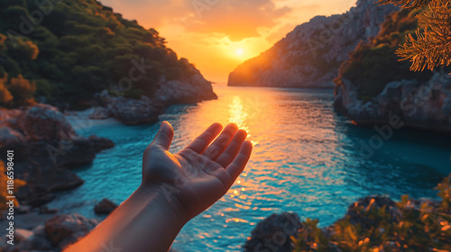 Sunset view with outstretched hand at a tranquil coastal bay photo