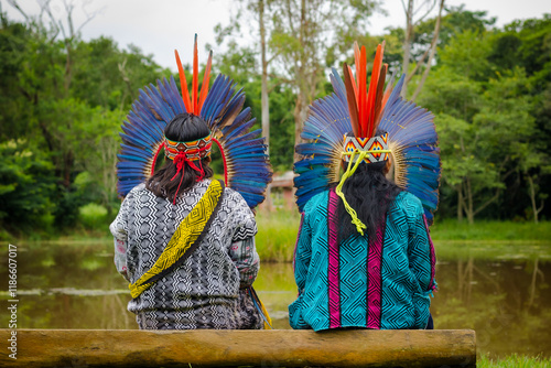 Sao Paulo, SP, Brazil - February 09 2020: Indigenous people, original people, sitting on a wooden bench on the riverbank details.