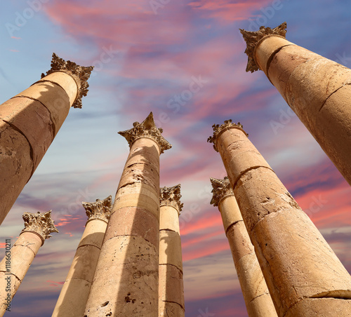 Roman Columns in the Jordanian city of Jerash (Gerasa of Antiquity), capital and largest city of Jerash Governorate, Jordan. Against the background of a beautiful sky with clouds photo